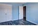 Bedroom with wood-look flooring and an attached closet at 1212 Southgate Dr, Raleigh, NC 27610