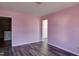 Bedroom with wood-look flooring and pink walls at 1212 Southgate Dr, Raleigh, NC 27610