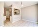 Bright dining area with tile floors offering an open view into the kitchen at 1212 Southgate Dr, Raleigh, NC 27610