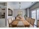 Bright dining room with a large wooden table and access to the outdoor area at 1212 Southgate Dr, Raleigh, NC 27610
