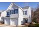 Charming two-story home features a garage and blue shutters for a classic look at 1212 Southgate Dr, Raleigh, NC 27610
