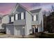 Charming two-story home features a garage and blue shutters for a classic look at dusk at 1212 Southgate Dr, Raleigh, NC 27610