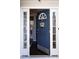 Inviting front door with sidelights, transom window, and a 'Welcome' wreath at 1212 Southgate Dr, Raleigh, NC 27610