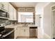A bright kitchen with modern appliances, elegant countertops, and sleek cabinetry at 1212 Southgate Dr, Raleigh, NC 27610