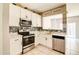 Well-appointed kitchen featuring stainless steel appliances, white cabinets, and quartz countertops at 1212 Southgate Dr, Raleigh, NC 27610