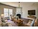 Inviting living room with a fireplace, hardwood floors, and large window for natural light at 1212 Southgate Dr, Raleigh, NC 27610