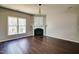 Spacious living room with a fireplace, hardwood floors, and large window for natural light at 1212 Southgate Dr, Raleigh, NC 27610
