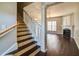 Open living room with staircase, hardwood floors, fireplace and abundant natural light at 1212 Southgate Dr, Raleigh, NC 27610