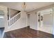 Spacious living room showcasing hardwood floors, staircase, and open doorways at 1212 Southgate Dr, Raleigh, NC 27610
