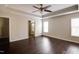 Cozy main bedroom features a tray ceiling, fan, and dark wooden floors at 1212 Southgate Dr, Raleigh, NC 27610