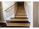 A creatively designed staircase with patterned risers and wooden handrail at 1212 Southgate Dr, Raleigh, NC 27610