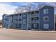 Contemporary blue apartment building with multiple units, balconies, and outdoor staircases at 1309 Hudson Ave # A7, Durham, NC 27705