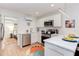 Modern kitchen features stainless steel appliances, white cabinets and countertops, and open access to the bedroom at 1309 Hudson Ave # A7, Durham, NC 27705