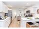 Bright kitchen featuring stainless steel appliances, white cabinets, and an eat-in breakfast bar at 1309 Hudson Ave # A7, Durham, NC 27705