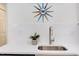 Close-up on a sleek kitchen sink with a stylish faucet, white countertops, and white subway tile backsplash at 1309 Hudson Ave # A7, Durham, NC 27705