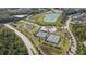 Aerial view shows community tennis courts and a pond area with green space, walking trails and parking at 167 Logbridge Rd, Chapel Hill, NC 27516