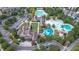 Aerial view of a community clubhouse featuring multiple pools, sunbathing decks, well-manicured landscaping, and a parking lot at 167 Logbridge Rd, Chapel Hill, NC 27516