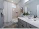 Bathroom with vanity, mirror, shower with curtain and tile, along with matching accessories at 167 Logbridge Rd, Chapel Hill, NC 27516