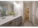 Bathroom with double sink vanity, large mirror, with walk in closet on tile flooring at 167 Logbridge Rd, Chapel Hill, NC 27516