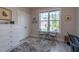 This bedroom is bright, with a window, a small table, and a gray patterned rug on the floor at 167 Logbridge Rd, Chapel Hill, NC 27516