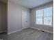 This bedroom features gray walls, gray wood floors, a large window, and a double-door closet at 167 Logbridge Rd, Chapel Hill, NC 27516