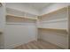 Walk-in closet with built in shelving and hanging racks for maximum storage capacity at 167 Logbridge Rd, Chapel Hill, NC 27516