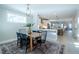 Dining area leading to kitchen and living areas showing an open-concept home with a large table at 167 Logbridge Rd, Chapel Hill, NC 27516
