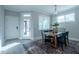 Dining area with a modern table, chairs, area rug, and natural light from nearby windows at 167 Logbridge Rd, Chapel Hill, NC 27516