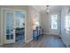 Bright entryway with French doors to an office, a white front door, light wood floors, and modern decor at 167 Logbridge Rd, Chapel Hill, NC 27516