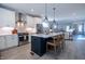 Bright and airy kitchen featuring a center island with seating and modern stainless steel appliances at 167 Logbridge Rd, Chapel Hill, NC 27516