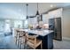 Modern kitchen with a large island, stainless steel appliances, and seating for a perfect cooking experience at 167 Logbridge Rd, Chapel Hill, NC 27516