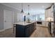 Open concept kitchen featuring an island with quartz countertops and stainless steel appliances at 167 Logbridge Rd, Chapel Hill, NC 27516