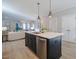 Open concept living space featuring a kitchen island with pendant lighting and stainless steel appliances at 167 Logbridge Rd, Chapel Hill, NC 27516