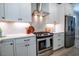 Modern kitchen featuring white cabinets, stainless steel appliances, and stylish backsplash at 167 Logbridge Rd, Chapel Hill, NC 27516
