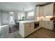 Bright kitchen featuring a center island, stainless steel microwave, and an adjacent dining area at 167 Logbridge Rd, Chapel Hill, NC 27516
