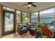 Screened-in porch with a ceiling fan, wood floors, and comfortable patio furniture at 167 Logbridge Rd, Chapel Hill, NC 27516