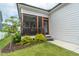 Screened-in porch with a wood-framed doorway, a small set of stairs, and green grass at 167 Logbridge Rd, Chapel Hill, NC 27516