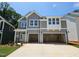 New construction home with grey siding, a two-car garage, and landscaping at 223 Augusta Pond Way # 158, Raleigh, NC 27603