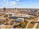 Drone view of apartment complex surrounded by lush landscapes and roadways, with a cityscape in the background at 600 S Duke St # 26, Durham, NC 27701