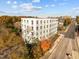 Exterior aerial view of contemporary apartment building surrounded by lush trees and neighborhood streets at 600 S Duke St # 26, Durham, NC 27701