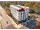 An aerial view of a modern apartment building situated on a tree-lined street on a clear fall day at 600 S Duke St # 26, Durham, NC 27701