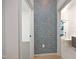 Hallway view into bathroom, showcasing stylish wallpaper accent and modern tile at 600 S Duke St # 26, Durham, NC 27701