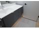 A modern bathroom featuring a vanity with gray cabinets, white countertop, and gray tiled floor at 600 S Duke St # 26, Durham, NC 27701