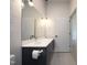 Bathroom features a modern vanity with gray cabinets, white countertop, and sleek mirror at 600 S Duke St # 26, Durham, NC 27701