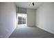 Bright bedroom with gray carpet, ceiling fan, and sliding door with balcony access at 600 S Duke St # 26, Durham, NC 27701