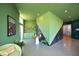 A vibrant common area with green walls, modern furniture, and plenty of natural light at 600 S Duke St # 26, Durham, NC 27701