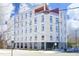 Modern building with white facade, large windows, and a rooftop terrace under a blue sky at 600 S Duke St # 26, Durham, NC 27701