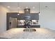 A modern kitchen boasts gray cabinets, stainless steel appliances, a stone countertop island, and stylish backsplash at 600 S Duke St # 26, Durham, NC 27701