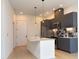 Modern kitchen features gray cabinets, stainless steel appliances, a stone countertop island, and backsplash at 600 S Duke St # 26, Durham, NC 27701