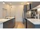 Modern kitchen featuring stainless steel appliances, granite countertops, and dark gray cabinetry at 600 S Duke St # 26, Durham, NC 27701